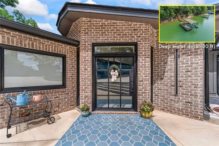 Aerial perspective showcasing the property's proximity to Lake Lanier, surrounded by extensive green landscape