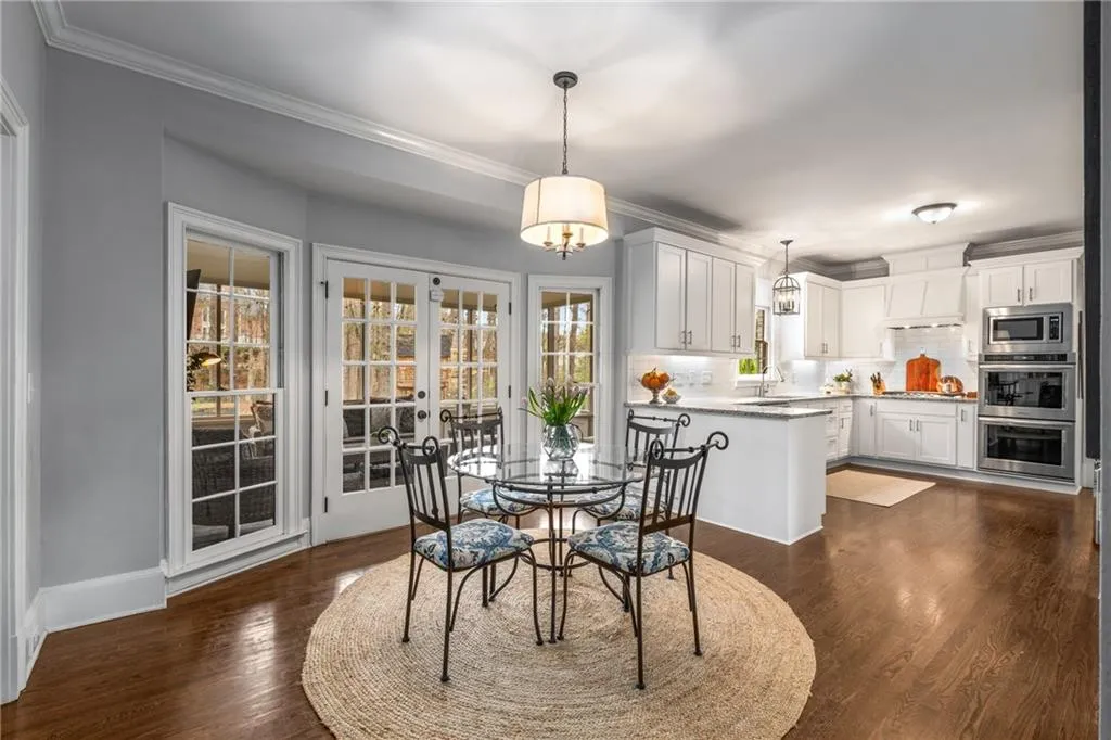 Dining space featuring ornamental molding, dark wood-type flooring, and baseboards