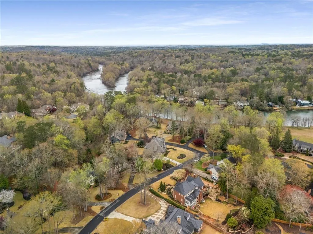 Aerial view with a water view and a view of trees