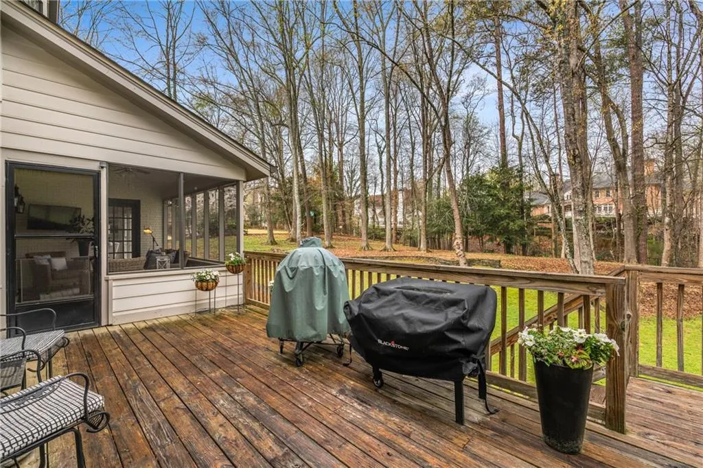 Deck featuring grilling area and a sunroom