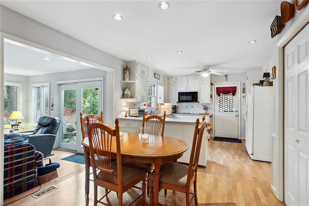 Dining area with light hardwood / wood-style floors and ceiling fan Dining area with light hardwood / wood-style floors and ceiling fan