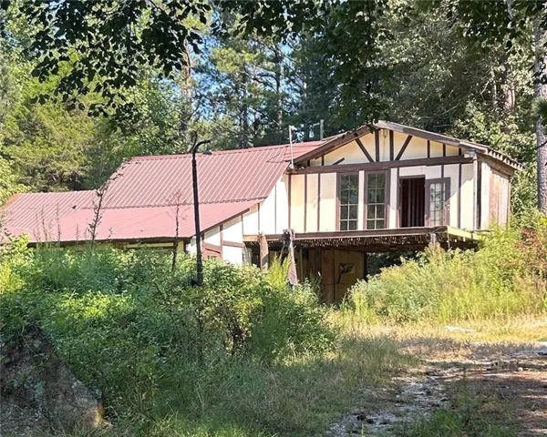 Back of property with a metal roof