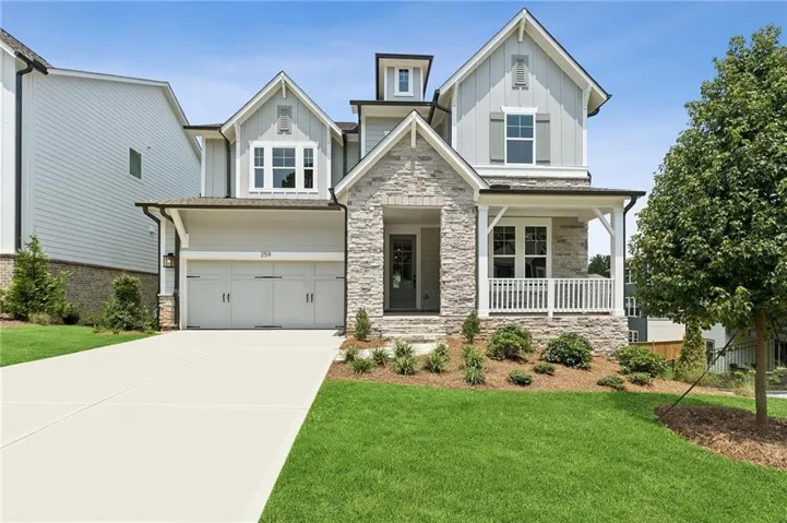 Craftsman-style facade featuring stone accents, gabled rooflines, and board and batten siding