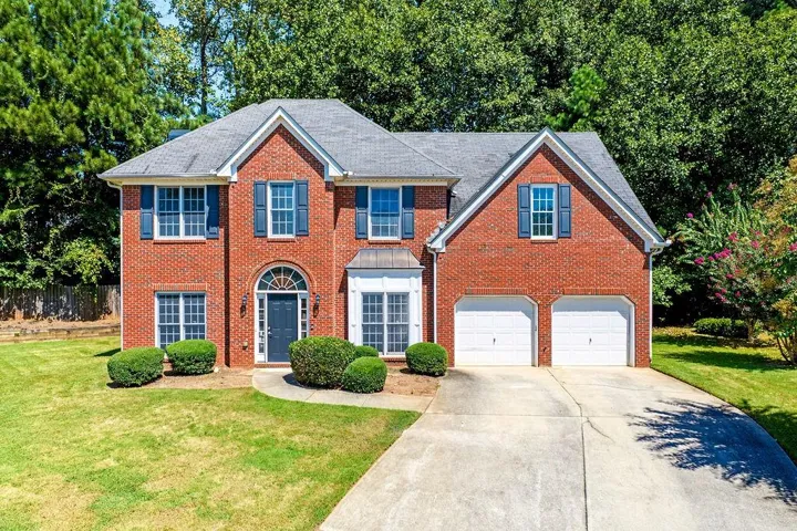 Brick exterior with a gray roof and white trim