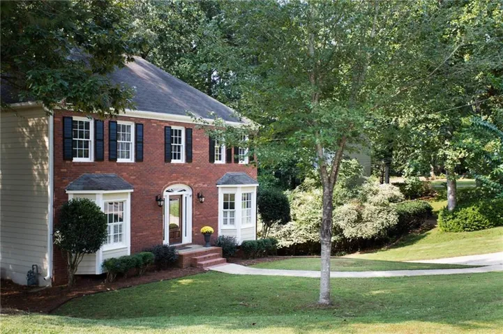 Traditional featuring a front yard and brick siding