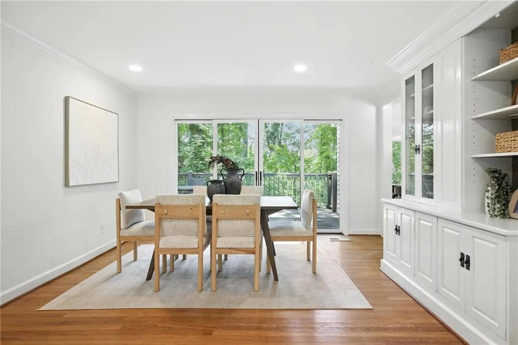 Dining space featuring ornamental molding, light wood-style floors, and recessed lighting