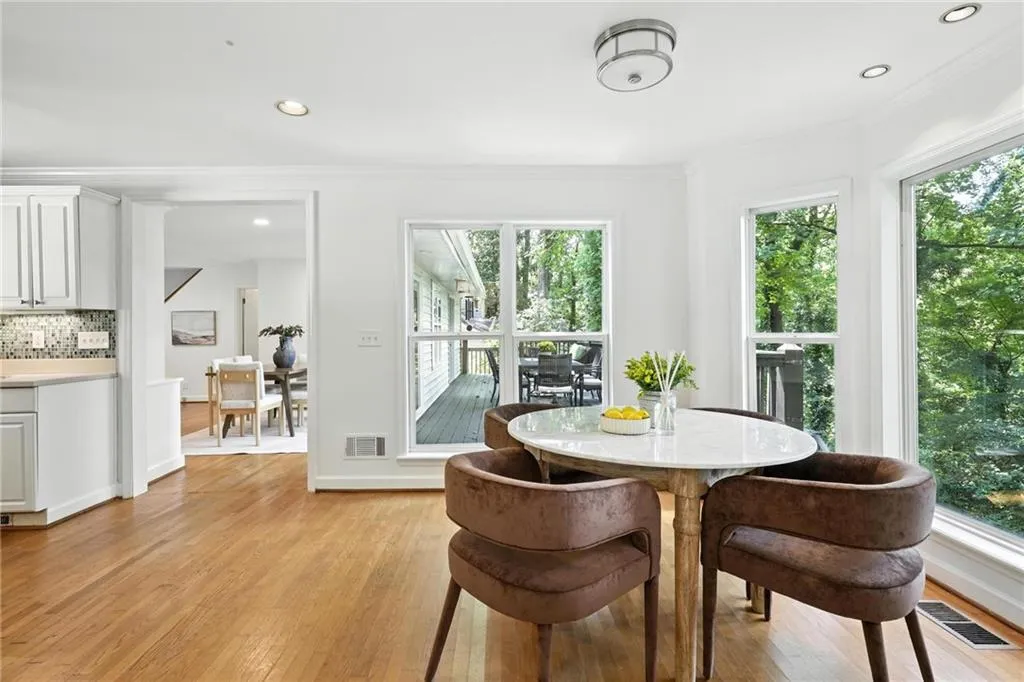 Dining space featuring light wood-style floors, crown molding, and recessed lighting