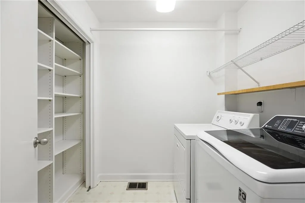 Laundry area featuring washer and clothes dryer and light floors