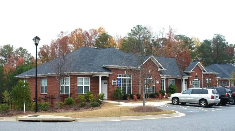 Ranch-style home with uncovered parking and brick siding
