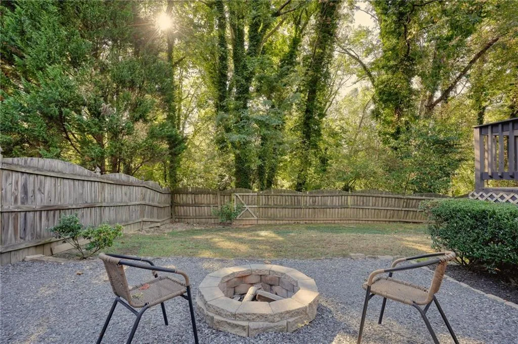 Fenced backyard featuring a fire pit