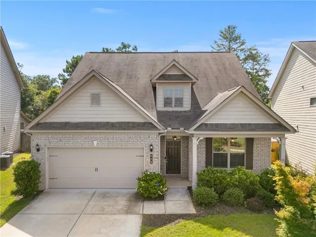 Light brick exterior with white siding accents