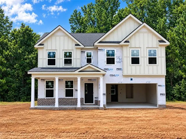 Two-story residence featuring light-colored vertical siding and a dark shingle roof