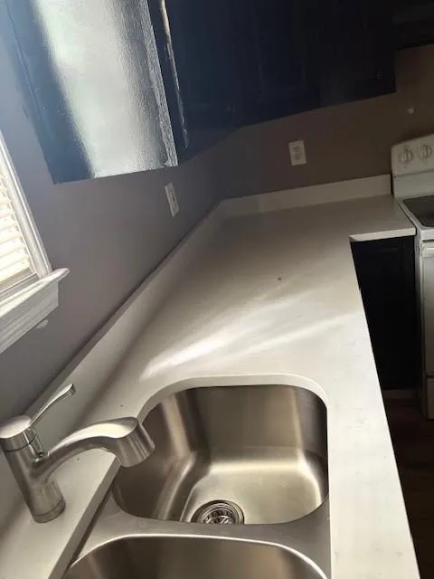 Kitchen view of stove and light countertops