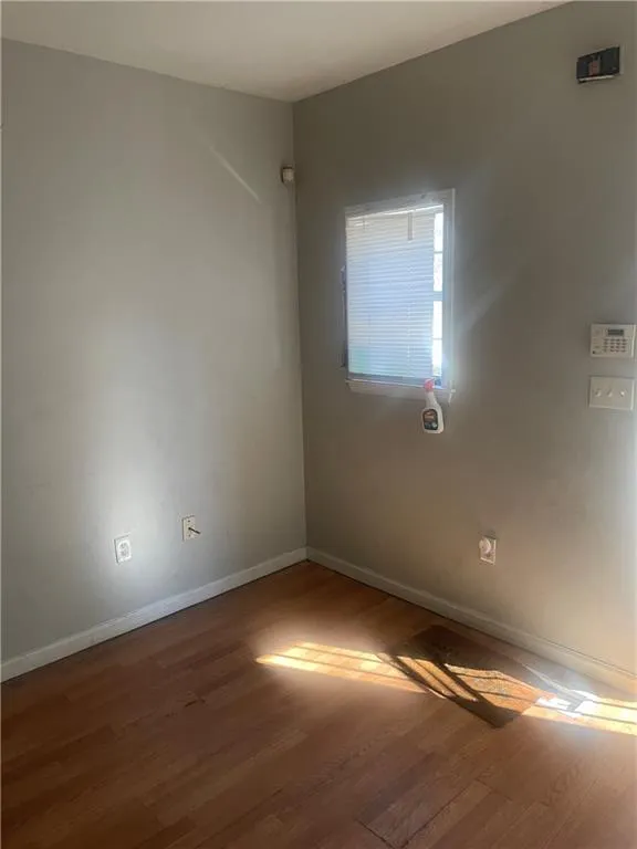 Empty room featuring hardwood / wood-style flooring