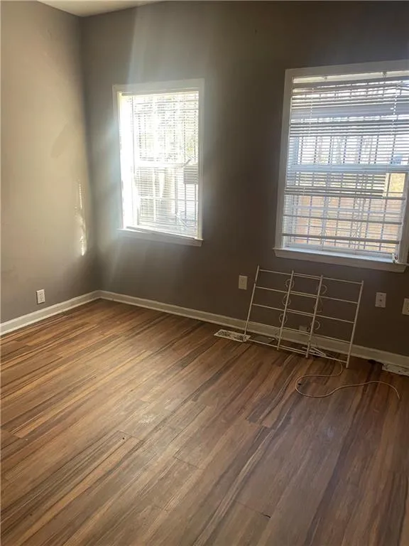 Unfurnished room featuring hardwood / wood-style flooring