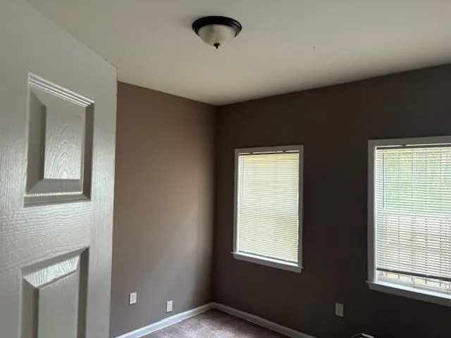 Spare room with carpet floors and baseboards