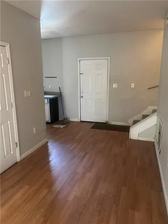 Laundry room with wood-type flooring
