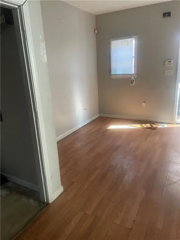 Empty room featuring hardwood / wood-style floors