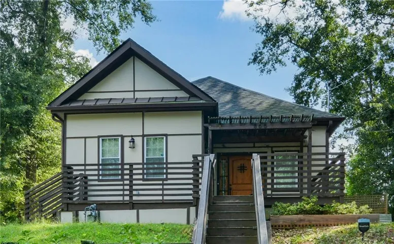 Exterior featuring a distinct gable roof, horizontal siding, and a prominent front entrance staircase