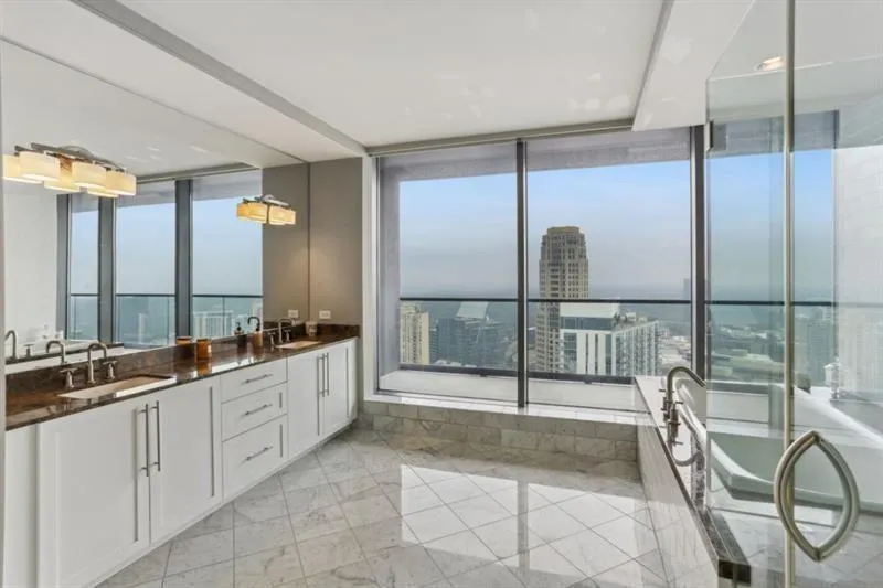 Bathroom with vanity, floor to ceiling windows, and a healthy amount of sunlight