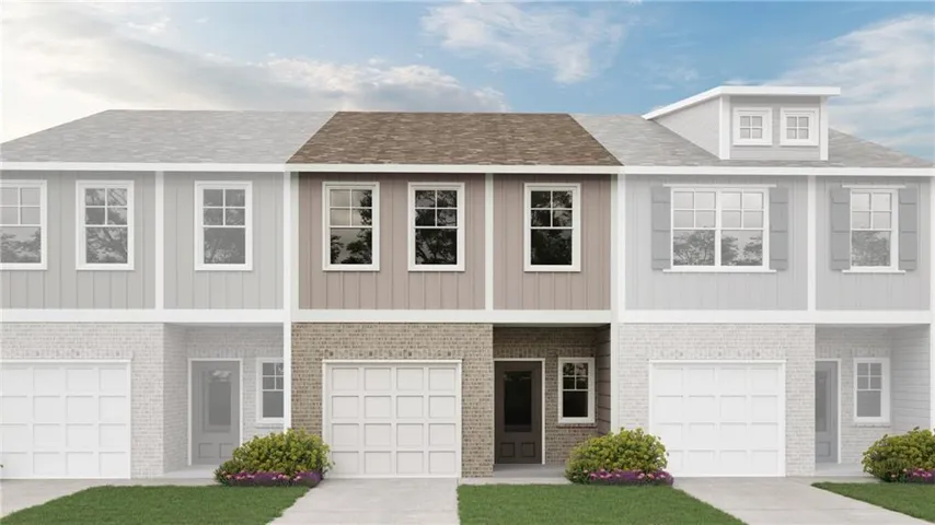 Contemporary townhome featuring a brick and board-and-batten facade, an integrated garage, a covered entry, and a dedicated walkway
