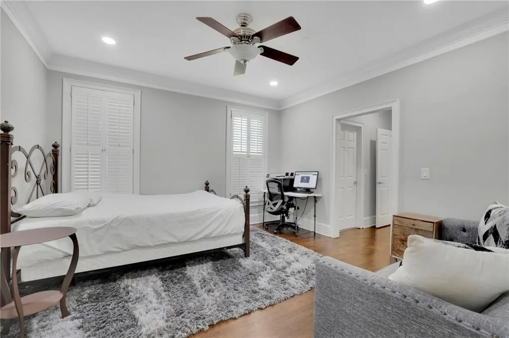 Bedroom featuring crown molding, wood finished floors, a desk, recessed lighting, and a ceiling fan