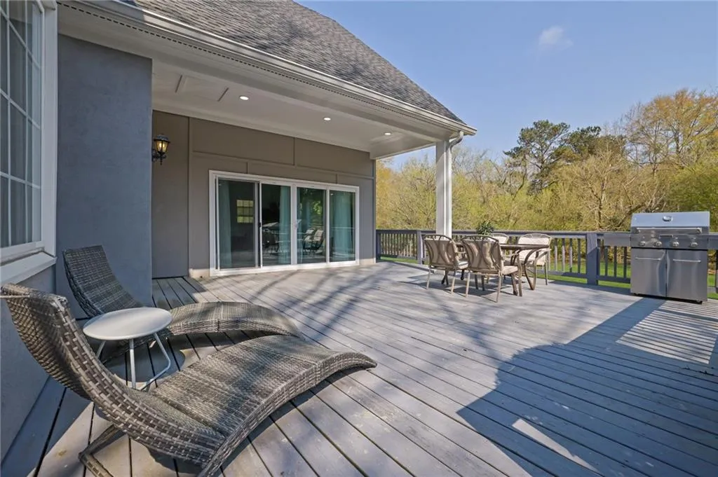 Deck featuring area for grilling and outdoor dining space