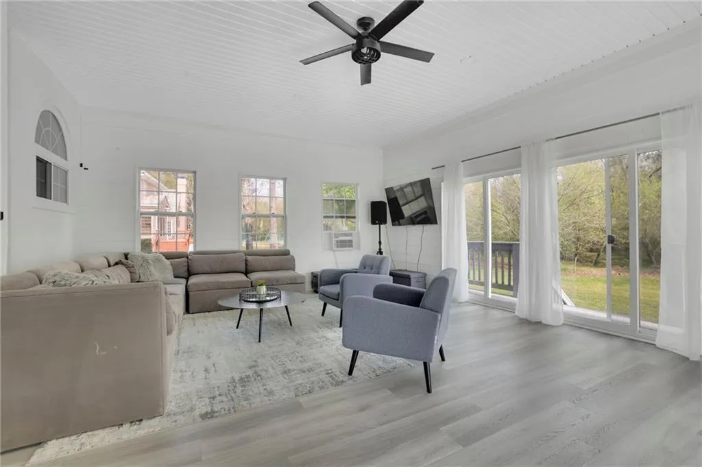 Living area featuring a ceiling fan and light wood-type flooring