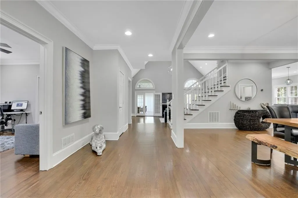 Entryway with ornamental molding, light wood-style floors, recessed lighting, and healthy amount of natural light
