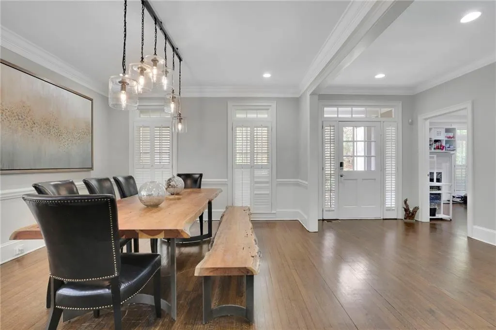 Dining space with ornamental molding, hardwood / wood-style floors, and recessed lighting