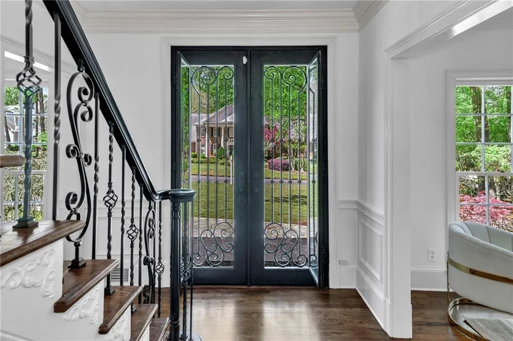 Foyer entrance with dark hardwood / wood-style flooring, french doors, and crown molding Foyer entrance with dark hardwood / wood-style flooring, french doors, and crown molding