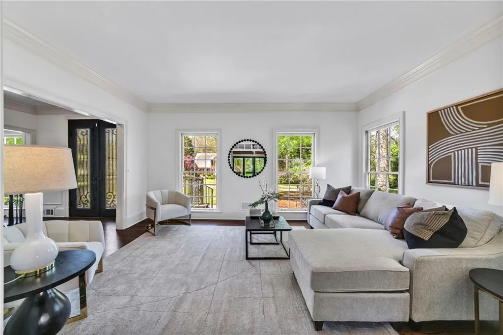 Living room featuring ornamental molding and light wood-type flooring Living room featuring ornamental molding and light wood-type flooring