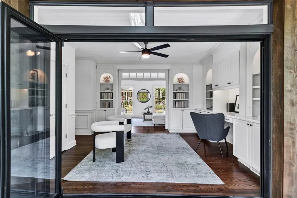 Office featuring ornamental molding, built in features, dark wood-type flooring, and ceiling fan Office featuring ornamental molding, built in features, dark wood-type flooring, and ceiling fan
