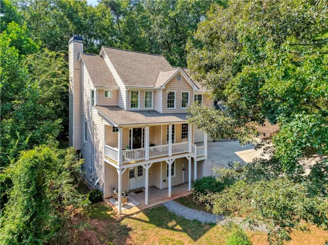 Welcome to 5250 Lanier Lane, where a wooded setting and inviting architecture create the feeling of a private retreat just minutes from Lake Lanier.