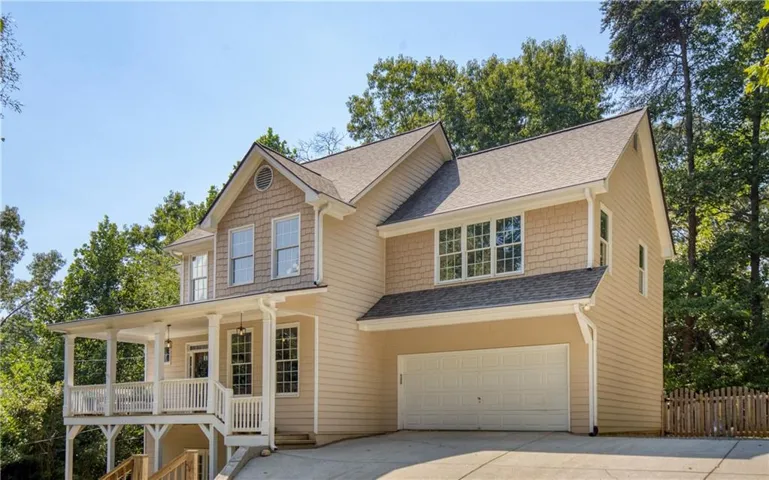 Welcome to 5250 Lanier Lane, where a wooded setting and inviting architecture create the feeling of a private retreat just minutes from Lake Lanier.