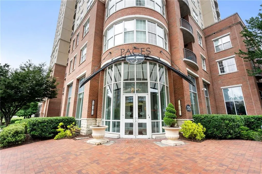 Entrance to property featuring french doors and brick siding