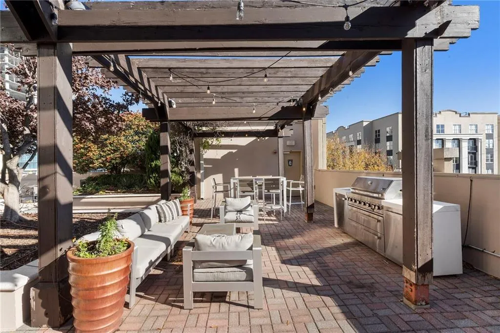 View of patio / terrace featuring a pergola, exterior kitchen, outdoor dining space, and outdoor lounge area