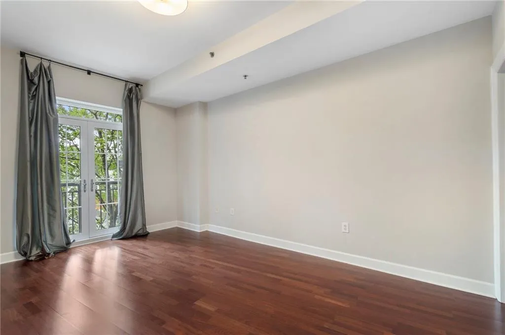 Spare room with baseboards and dark wood finished floors
