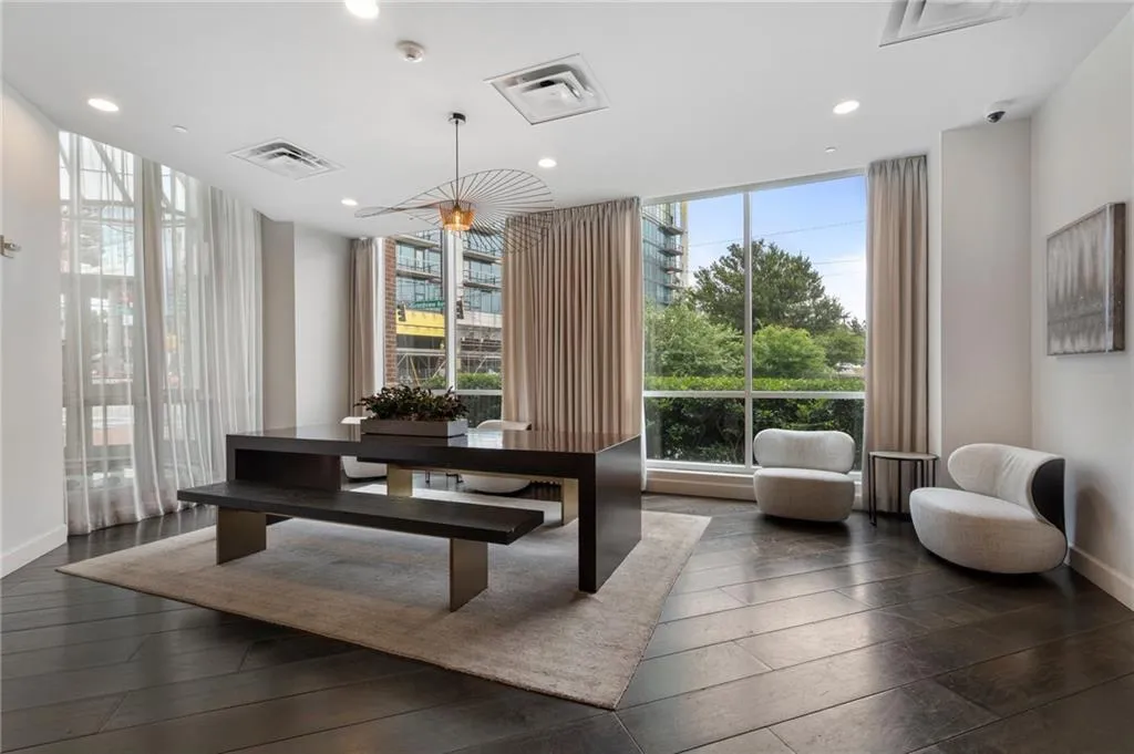 Dining space featuring dark wood-type flooring, baseboards, recessed lighting, and expansive windows