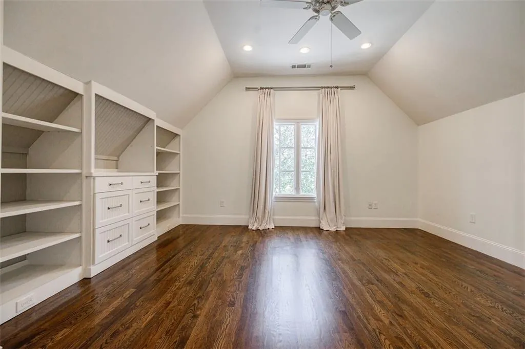 Upper Level super sized secondary bedroom with trey ceiling & built in bookshelves