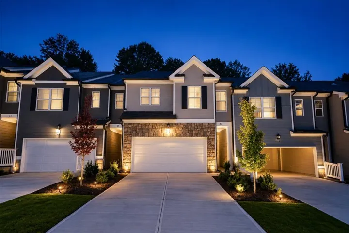 Exterior featuring stone accents, gabled rooflines, dark siding, and white trim