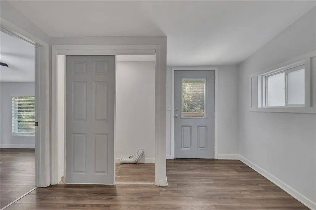 Foyer entrance featuring baseboards and wood finished floors