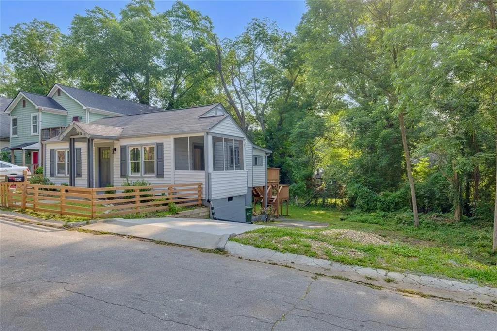 View of front facade with crawl space and a sunroom
