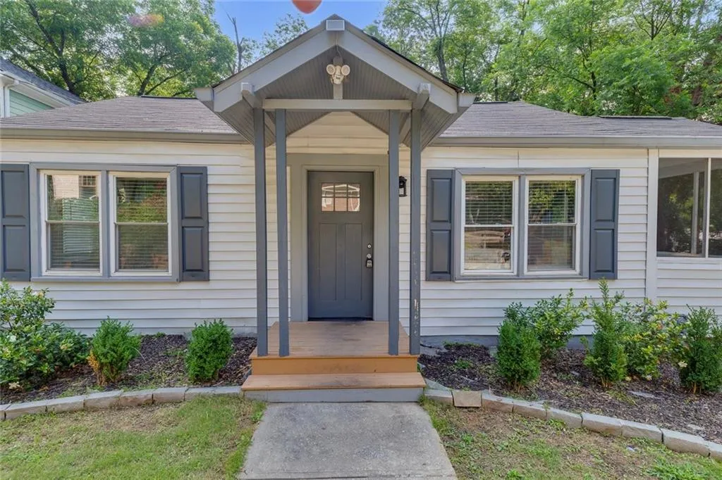 Property entrance featuring roof with shingles