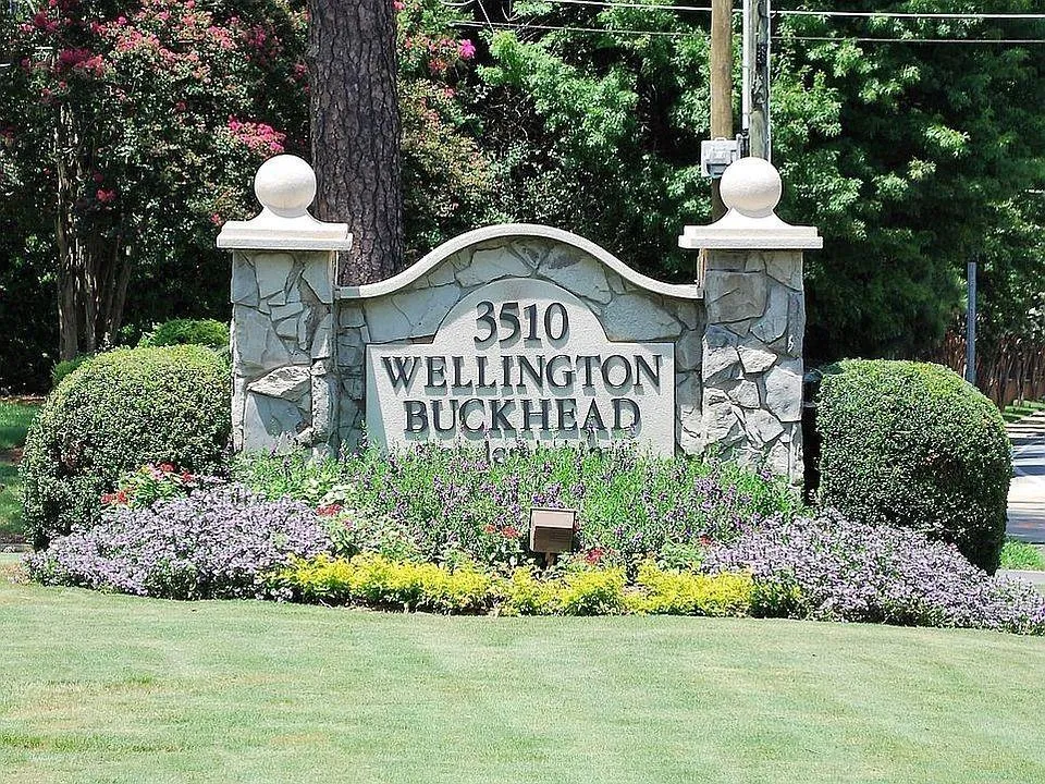 Stone monument sign featuring a decorative arch and address numbers