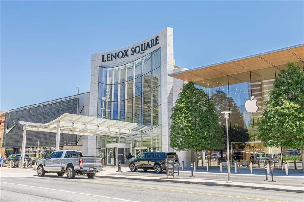 Modern commercial building featuring a prominent glass facade, a large "LENOX SQUARE" sign, and a contemporary architectural design