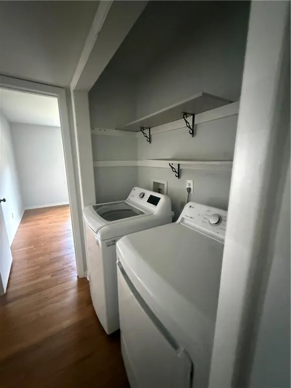Dedicated laundry nook featuring a top-load washer and front-load dryer