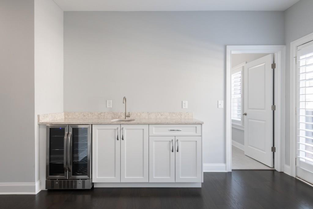 Wet Bar and wine refrigerator in Bonus r Room that extends onto rooftop terrace