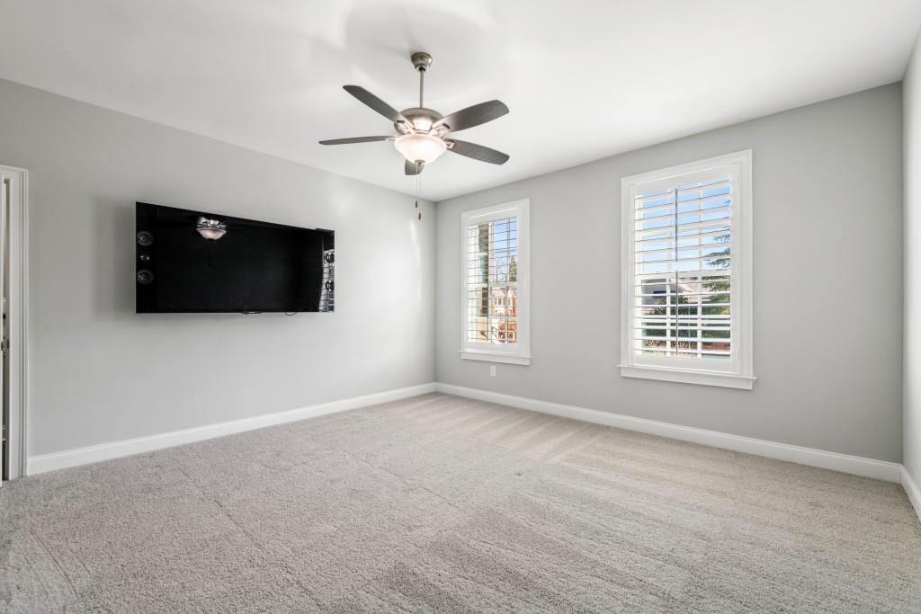 2ND FLR bedroom with ceiling fan and large windows