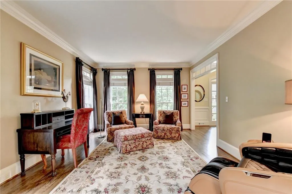 Living room with crown molding and light wood-style floors